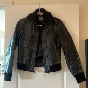 Genuine leather - Made and purchased in Spain . Beautifully broken in- comfy!